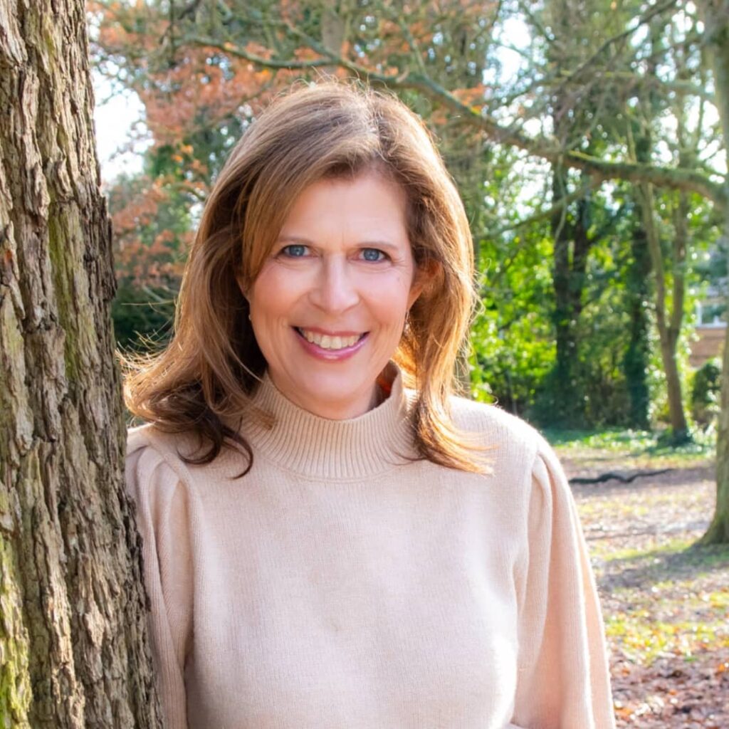 Maryanne in some woods, smiling to the camera